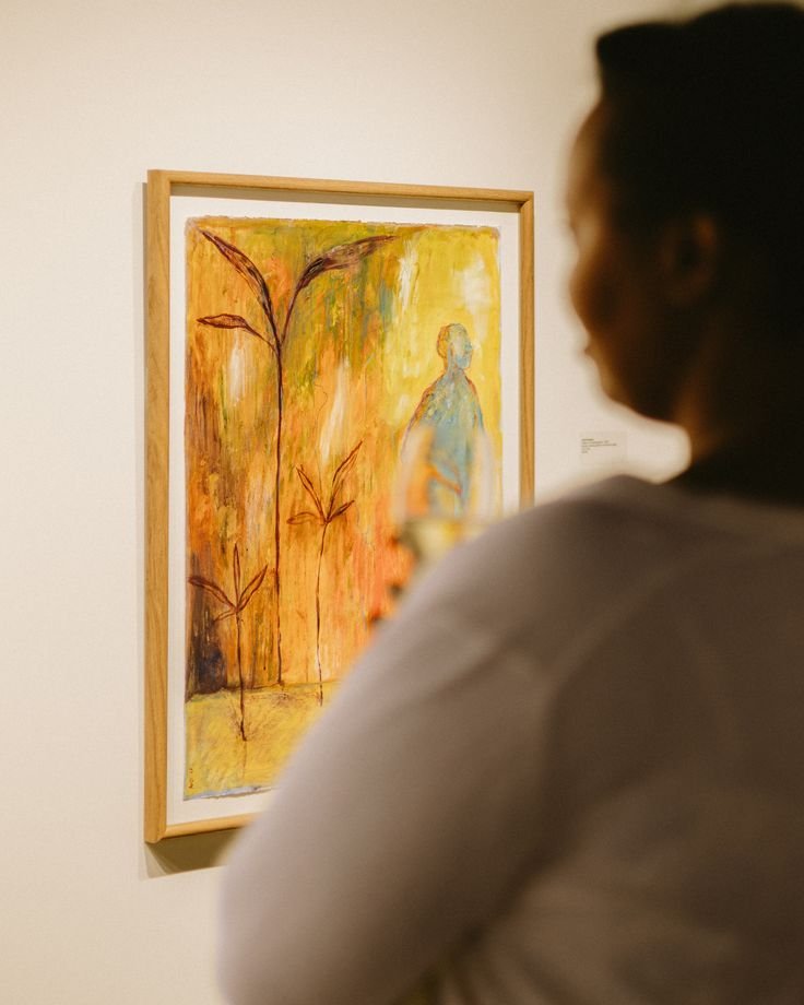 Guest viewing a painting in the gallery at SOMA