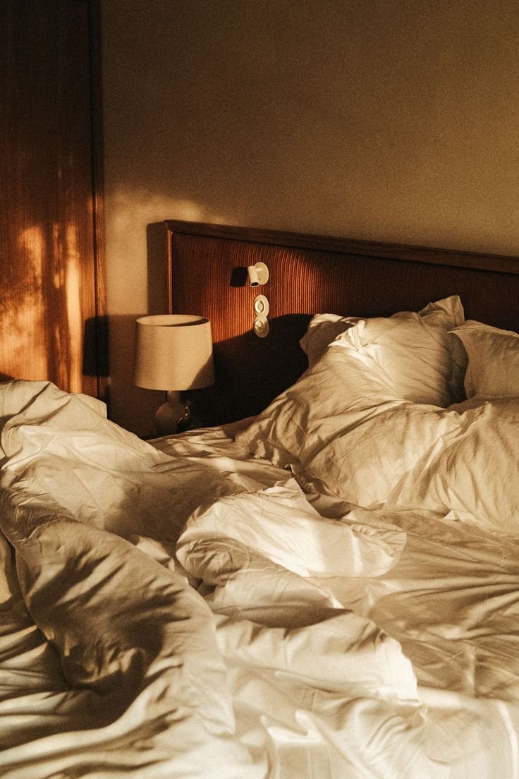 Bed with soft white linen in a SOMA suite